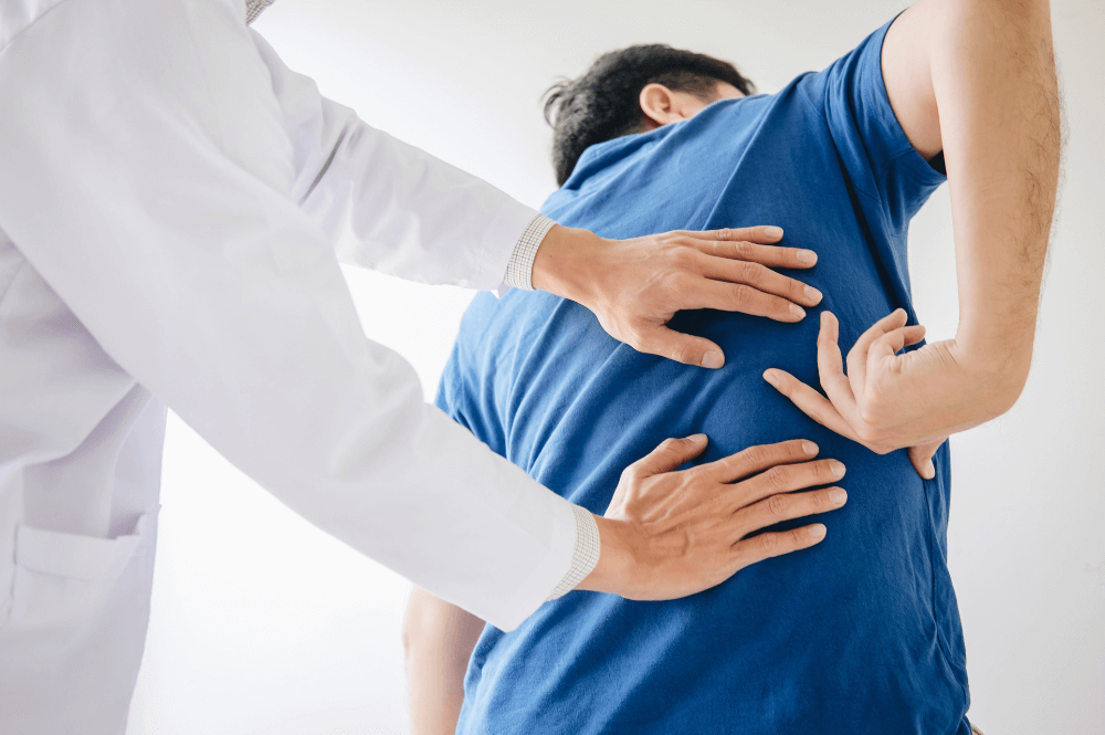 Doctor examining a patients back pain