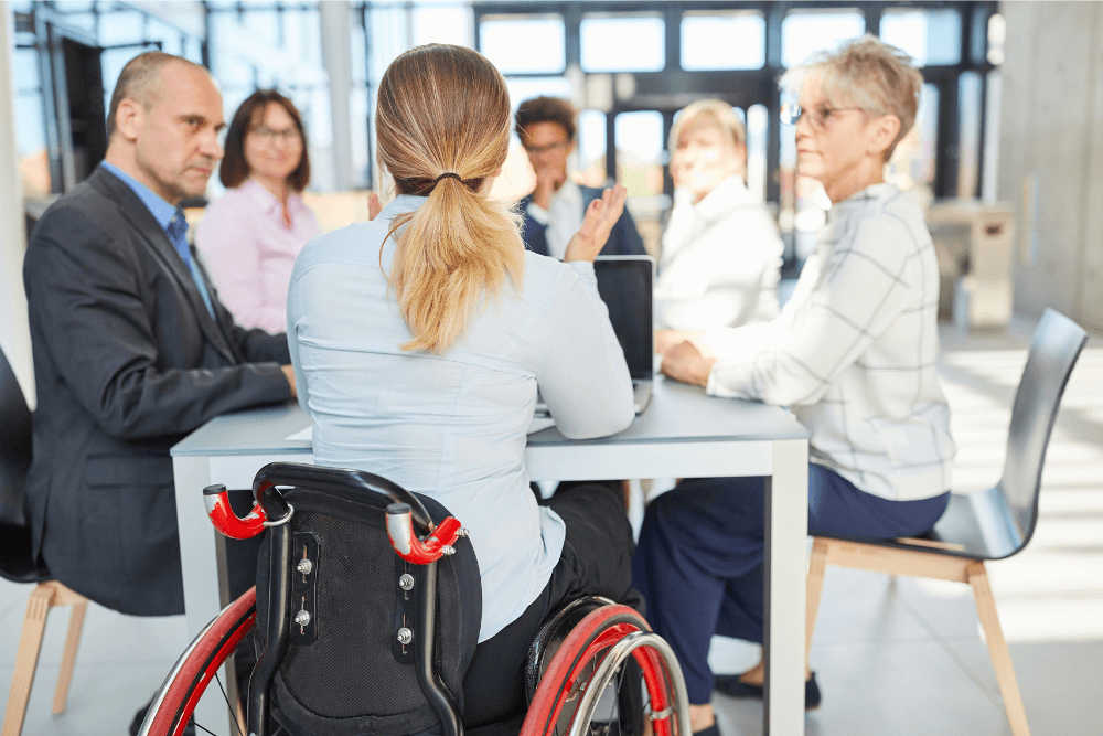 Handicap woman sitting at a conference table